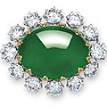 A magnificent oval jadeite cabochon and diamond pendant-brooch, mounted by carvin french