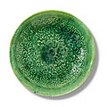 A molded green-glazed dish, liao dynasty (907-1125)