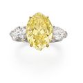 A 8.06 carats marquise-cut fancy vivid yellow diamond ring 