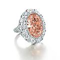 Rare 12.85ct oval-shaped fancy intense orangy pink diamond and diamond ring