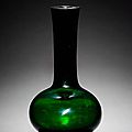 A green glass vase with tapering cylindrical neck and oviform body. Qianlong four-character mark © 2002-2010 Bonhams 1793 Ltd
