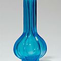 A hexagonal transparent blue glass vase