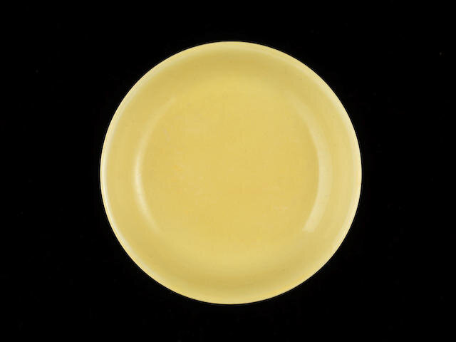 A yellow-glazed saucer dish, Hongzhi six-character mark and of the period (1487-1505)