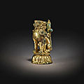 A rare gilt-bronze figure of a lion, tang dynasty (618-906)
