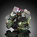 Dioptase, fluorite, iridescent hematite, opal aura quartz, rhodochrosite, tourmaline