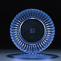A very rare imperial transparent blue glass 'chrysanthemum' dish, Qianlong incised four-character mark within double-squares and of the period (1736-1795)