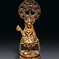 A small gilt-bronze figure of seated avalokiteshvara, late tang dynasty, 8th-9th century