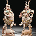 A rare large pair of painted and gilded pottery figures of lokapalas, Tang dynasty (618-907) 