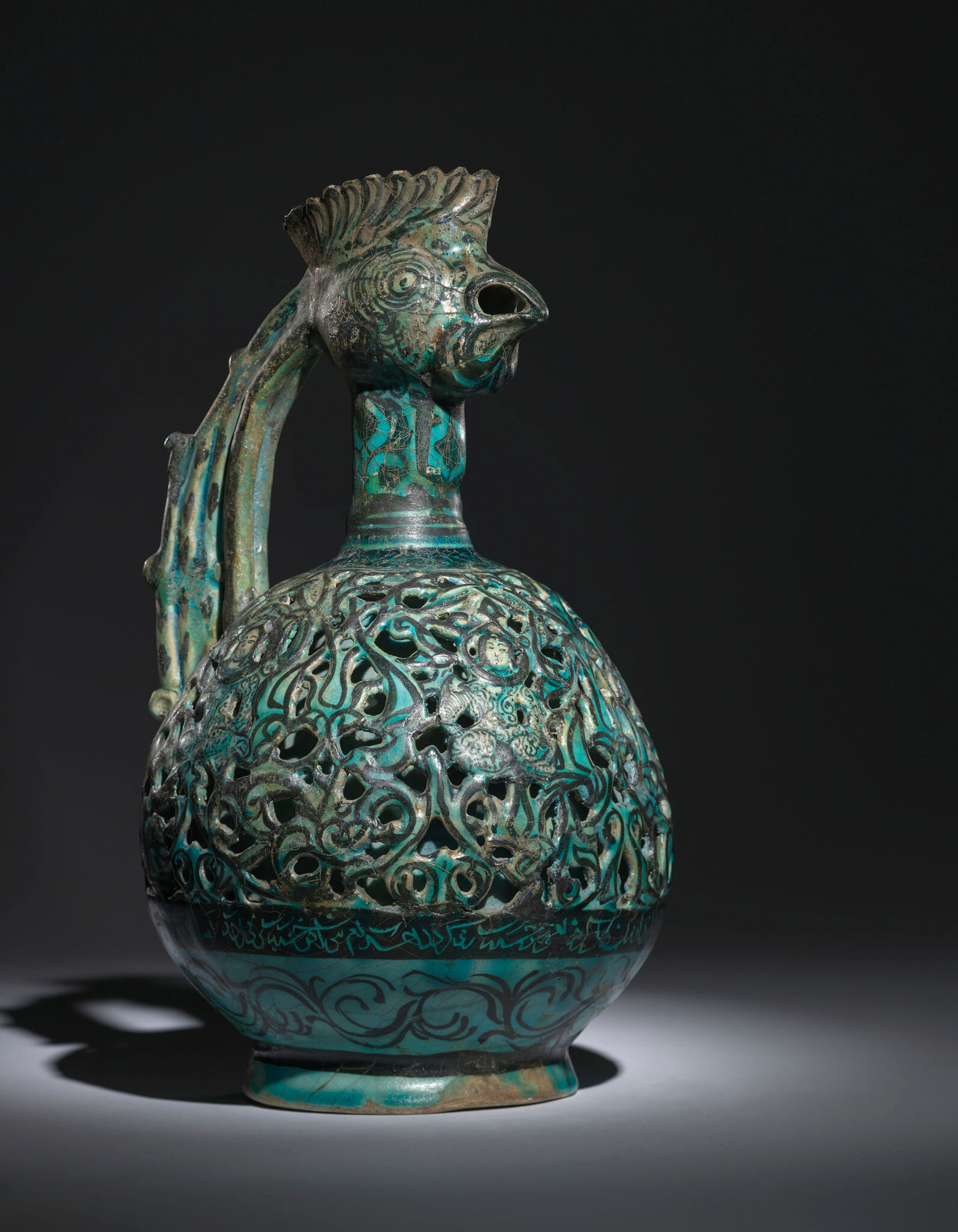 A Kashan Turquoise Glazed Reticulated Cockerel-head Pottery Ewer 