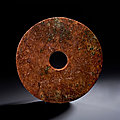 A large reddish-brown jade bi disc, neolithic period, liangzhu culture, 4th-3rd millenium bc