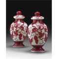 A pair of red-overlay white glass jars and covers. qing dynasty, 19th century