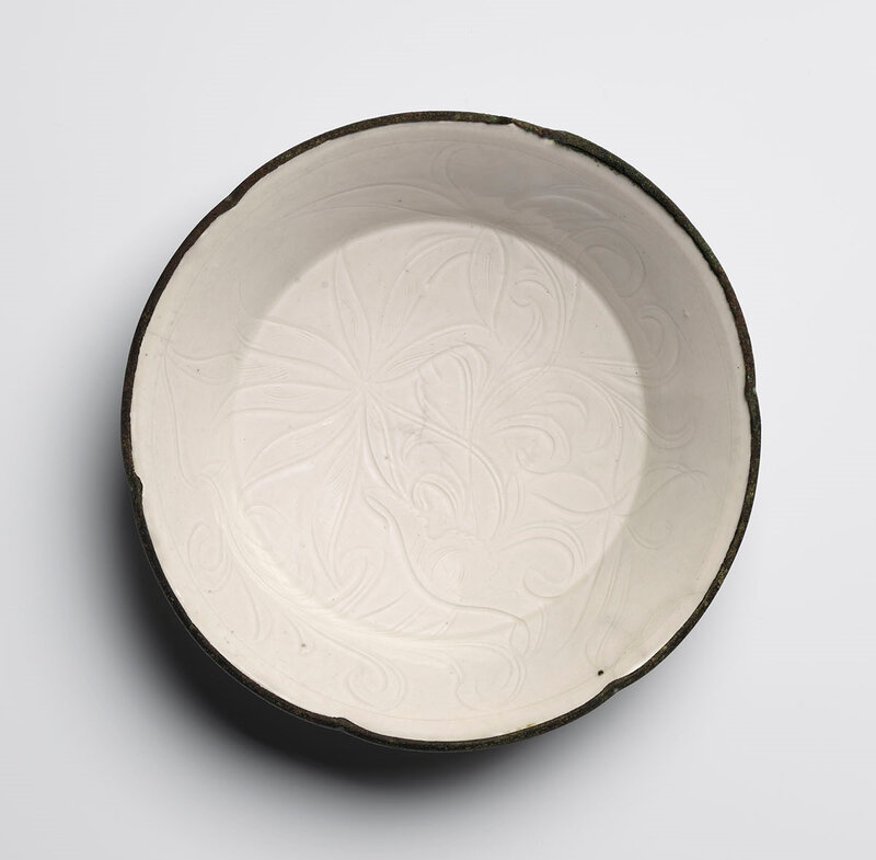 Glazed Porcellaneous Stoneware ‘Lotus’ Dish, Northern Song period, 11th - 12th century, Ding kilns, Hebei province. Diameter: 18.0cm. © Eskenazi
