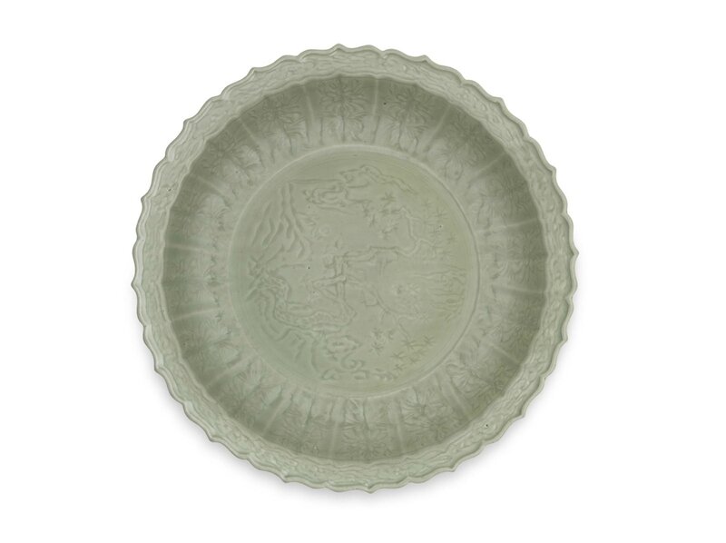 A large Longquan celadon-glazed carved barbed-rim dish, Early 15th century