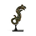 A bronze 'feline' handle, zhou dynasty