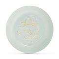 A rare white-glazed biscuit-decorated 'dragon' dish,Hongzhi six-character mark in underglaze blue within a double circle and of the period (1488-1505)